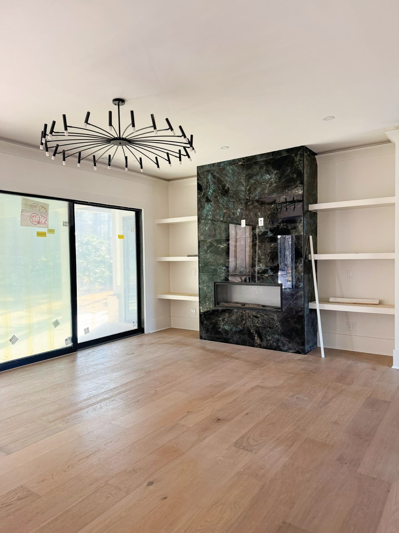 Finished modern living room flooring after material selection and installation.