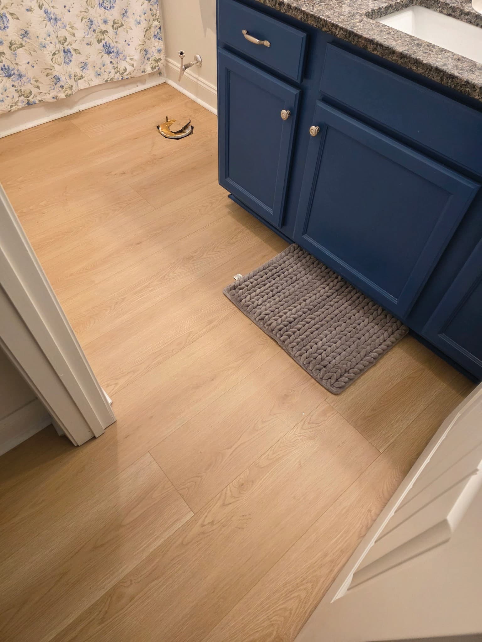 Bathroom flooring renovation after image with finished tile.
