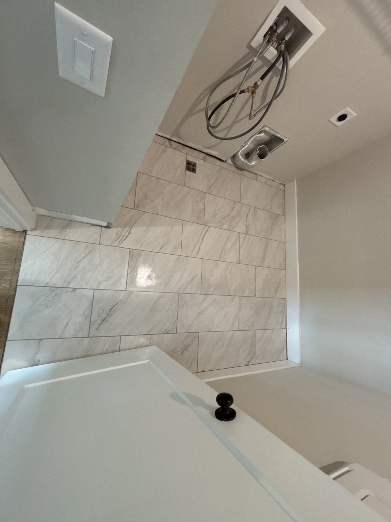 Calacatta marble-look porcelain tile in a luxury Atlanta powder room.